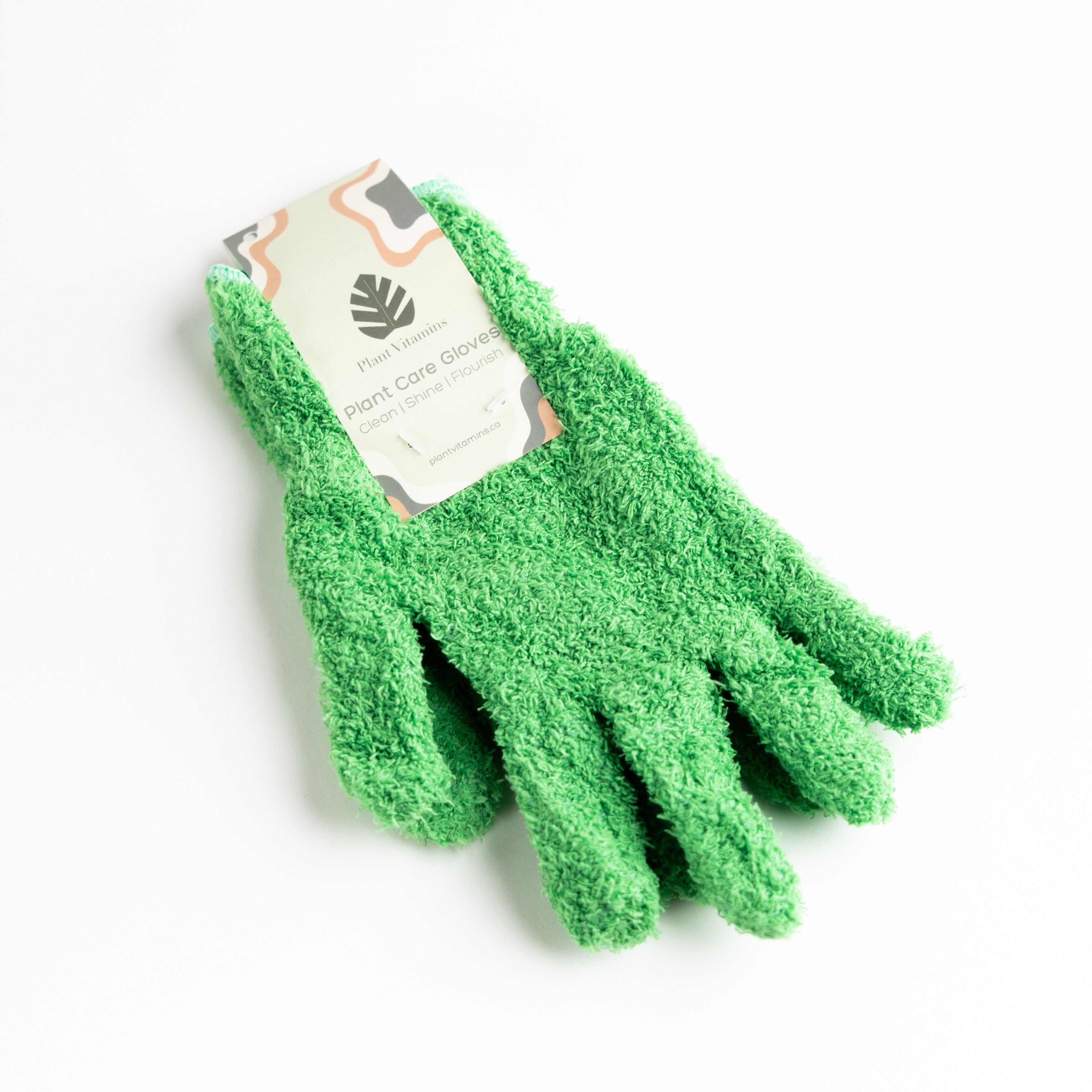 Green gardening gloves with a brand label on a white background